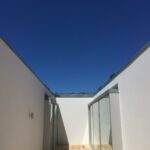 Alcino Soutinho's design of the Soutinho 14 Villas at Bom Sucesso Resort in Obidos, showcasing composite material structures with concrete elements, daylighting features, and plaster finishes creating shade and shadow effects.