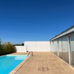 Alcino Soutinho's design of the Soutinho 14 Villas at Bom Sucesso Resort in Obidos showcases a modern villa with a composite material structure, featuring a swimming pool, tile accents, and daylighting elements in an eco-friendly hotel setting.