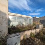 Alcino Soutinho's design of the Soutinho Conjunto de 28 Habitações em Banda at Bom Sucesso Resort, Obidos, showcasing composite material and concrete structures with glass balconies and daylighting features.