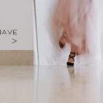 Álvaro Siza Vieira's O Espaço de Siza no Bom Sucesso – Nave Lagoa at Bom Sucesso Resort, Obidos, showcasing a symmetrical interior design with composite material flooring, a glass ceiling, and engineering elements.