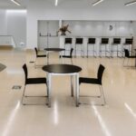 Álvaro Siza Vieira's O Espaço de Siza no Bom Sucesso – Nave Lagoa at Bom Sucesso Resort, Obidos, showcasing an interior design with a unique ceiling structure and ample daylighting.