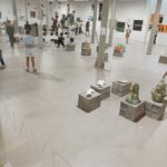 Álvaro Siza Vieira's O Espaço de Siza no Bom Sucesso – Nave Lagoa at Bom Sucesso Resort, Obidos, showcasing a blend of composite materials with tile and wood flooring, concrete elements, and natural materials in its design.