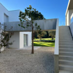 David Chipperfield's Chipperfield 4 Villas at Bom Sucesso Resort in Obidos showcasing a modern residential design with concrete walls, landscaped gardens, and a central courtyard.