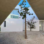 David Chipperfield's Chipperfield 4 Villas at Bom Sucesso Resort, Obidos, showcasing a modern concrete structure with ample daylighting features.