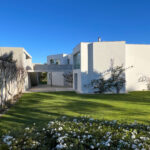 David Chipperfield's Chipperfield 4 Villas no Bom Sucesso showcasing a modern residential design with concrete structures, landscaped gardens, and expansive lawns at the Bom Sucesso Resort in Obidos.